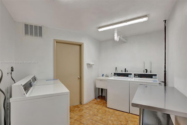 laundry area with washer and clothes dryer and sink