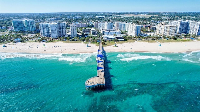 birds eye view of property with a water view and a view of the beach