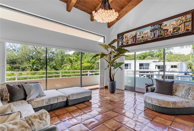 living room with beamed ceiling, wooden ceiling, high vaulted ceiling, and a chandelier