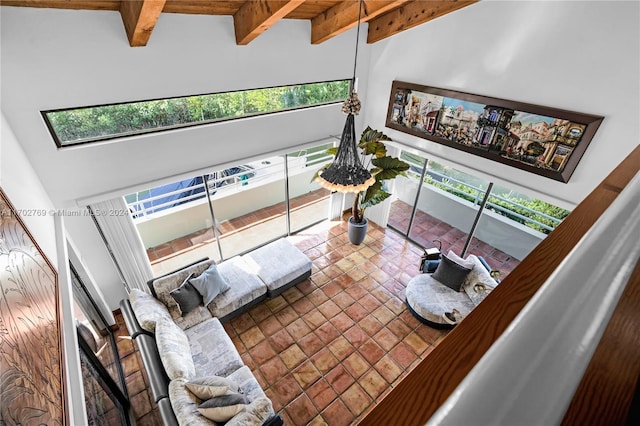 living room with a healthy amount of sunlight and high vaulted ceiling