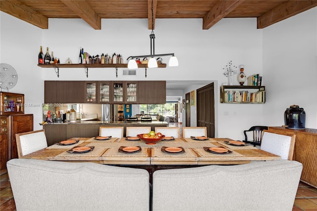 tiled dining area with beam ceiling and wooden ceiling