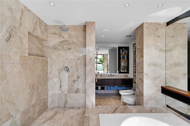 bathroom featuring vanity, a tile shower, a bidet, and tile walls