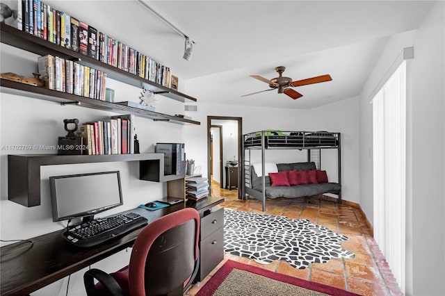 bedroom featuring ceiling fan, light tile patterned floors, and rail lighting