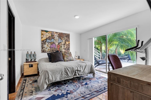 bedroom featuring access to outside and hardwood / wood-style flooring