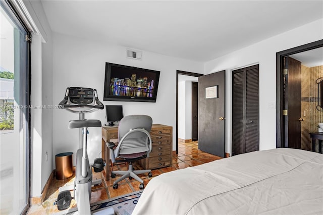 tiled bedroom featuring a closet