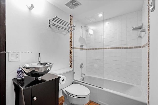 full bathroom featuring vanity, toilet, and tiled shower / bath