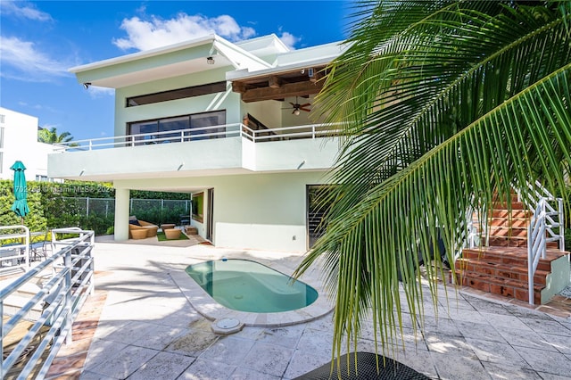 view of pool featuring ceiling fan, a patio area, and an outdoor living space