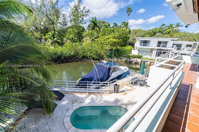 view of pool with a water view and a dock