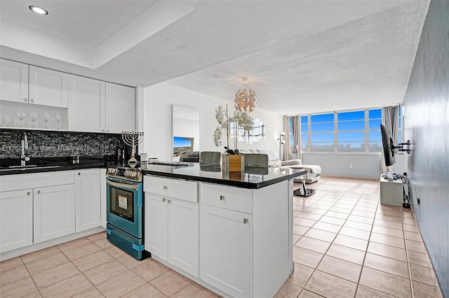 kitchen featuring white cabinetry, kitchen peninsula, sink, and stainless steel electric range