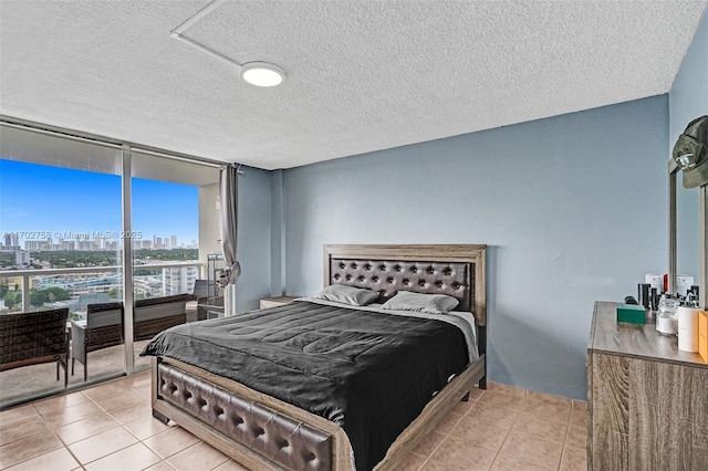 bedroom featuring a textured ceiling and light tile patterned floors