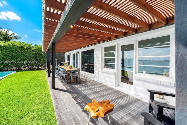 wooden deck with outdoor dining space, a yard, and a pergola