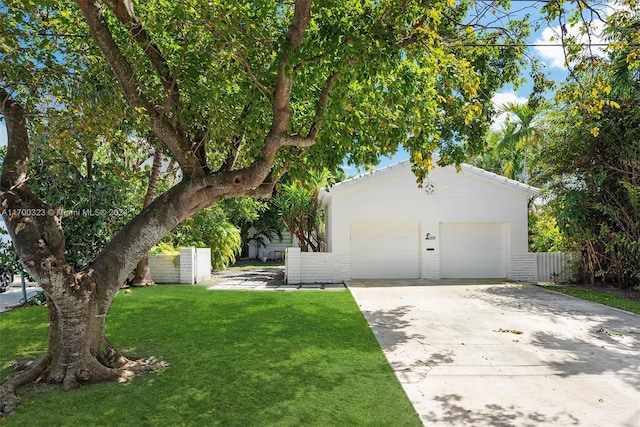 ranch-style home featuring concrete driveway, brick siding, a front lawn, and fence