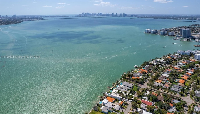 birds eye view of property with a water view and a city view