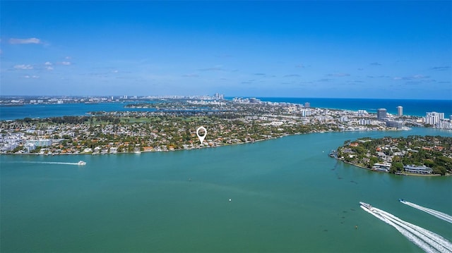 birds eye view of property featuring a view of city and a water view