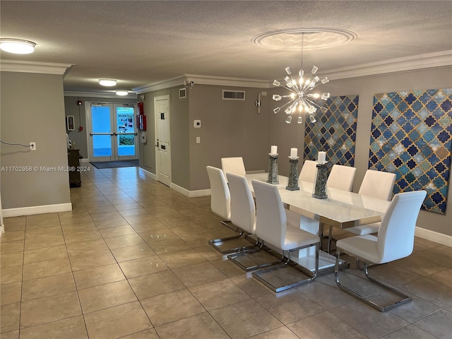 dining space featuring a chandelier, a textured ceiling, tile patterned floors, and ornamental molding