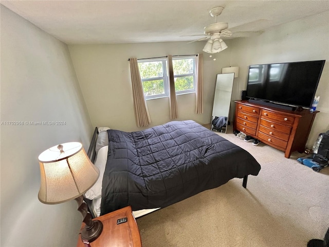 bedroom with ceiling fan and light carpet