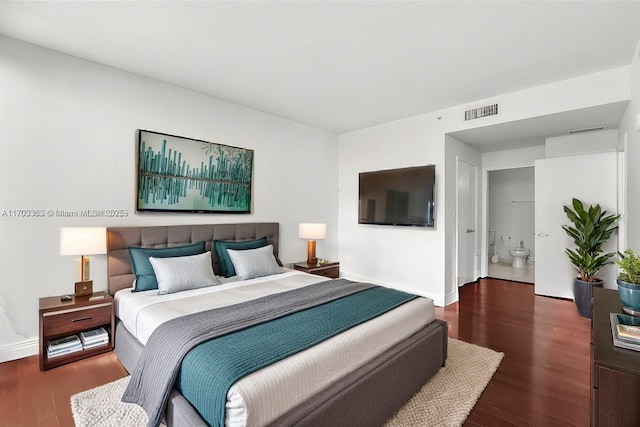 bedroom with dark hardwood / wood-style floors