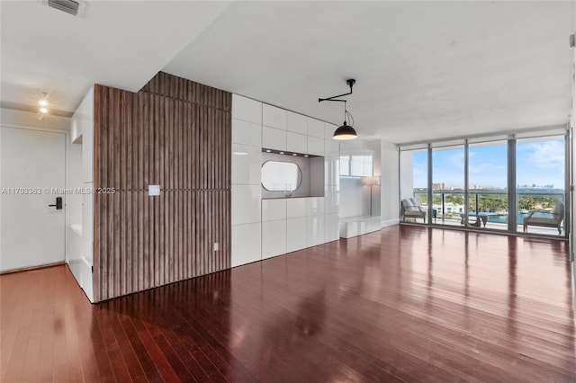 interior space featuring expansive windows and hardwood / wood-style flooring