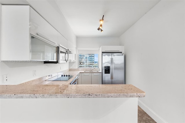 kitchen featuring appliances with stainless steel finishes, sink, and white cabinets