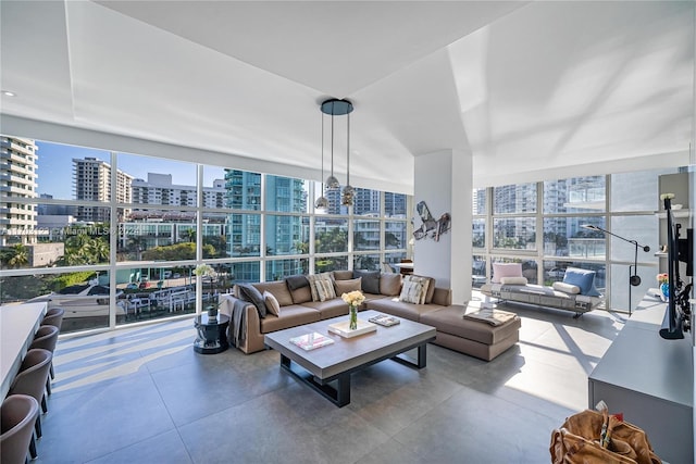 living room with a wall of windows and a healthy amount of sunlight