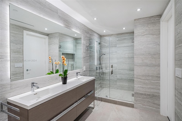 bathroom featuring vanity, an enclosed shower, and tile walls