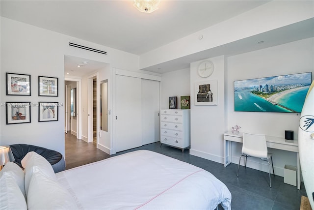 bedroom featuring built in desk and a closet