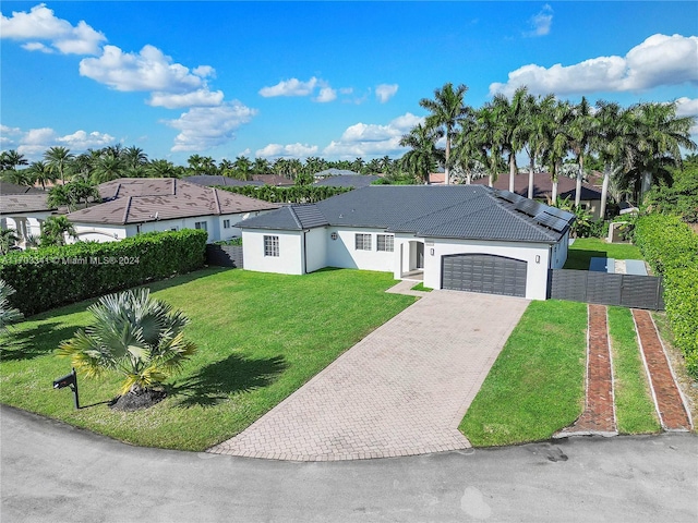 view of front of home featuring a garage and a front lawn