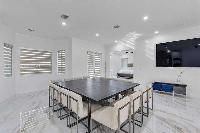 dining space featuring ceiling fan and crown molding