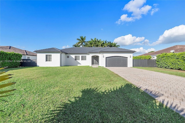 view of front of property featuring a garage and a front lawn