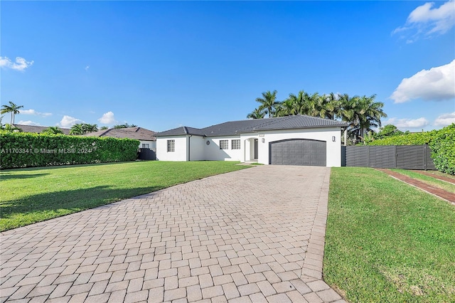 view of front of home featuring a garage and a front lawn