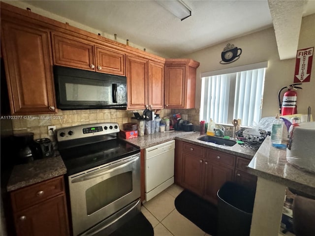 kitchen with stone counters, dishwasher, sink, tasteful backsplash, and stainless steel electric stove