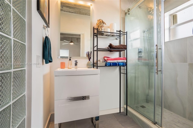 bathroom with tile patterned floors, ceiling fan, walk in shower, and vanity