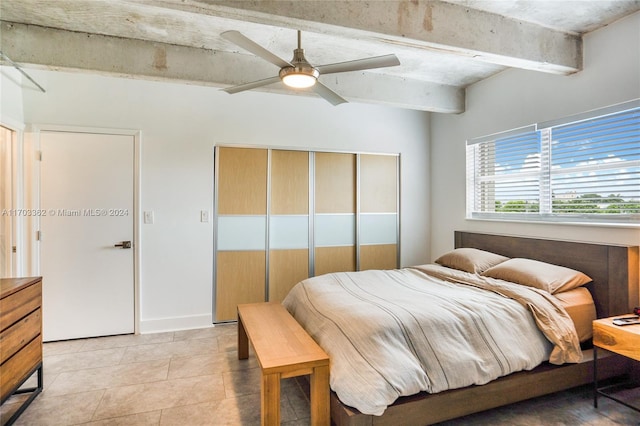 tiled bedroom with beamed ceiling and ceiling fan