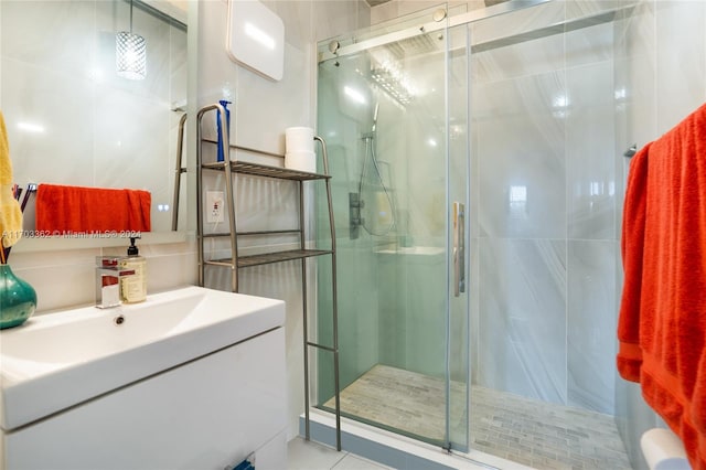 bathroom with vanity and a shower with shower door