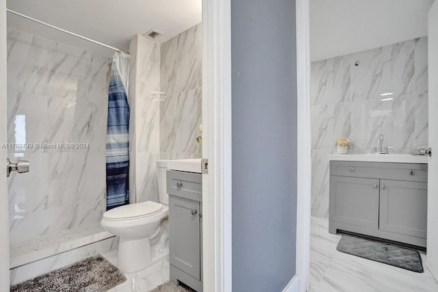 bathroom with a shower with shower curtain, vanity, toilet, and tile walls