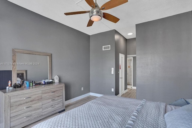 bedroom with light hardwood / wood-style floors and ceiling fan