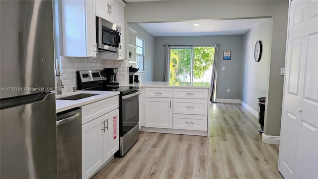 kitchen with backsplash, light wood-type flooring, white cabinetry, and stainless steel appliances