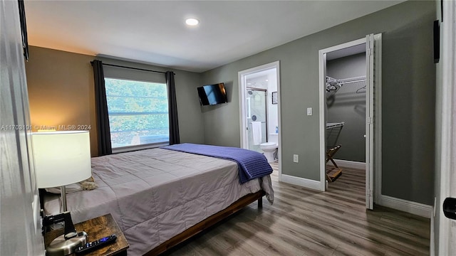 bedroom with a closet, ensuite bathroom, and hardwood / wood-style floors