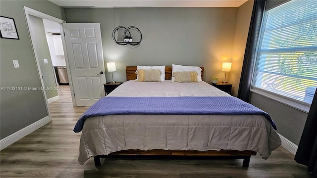 bedroom featuring hardwood / wood-style floors and multiple windows