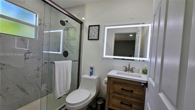 bathroom with vanity, an enclosed shower, and toilet