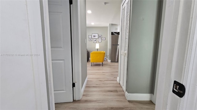 hallway with light hardwood / wood-style flooring