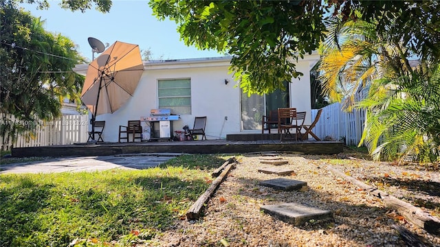 rear view of house featuring a deck