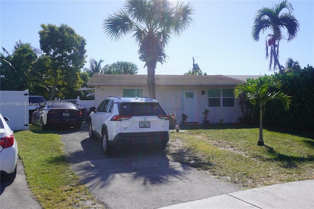 single story home featuring a front lawn