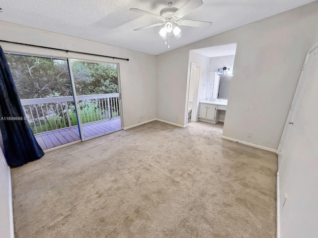 carpeted empty room with a textured ceiling and ceiling fan