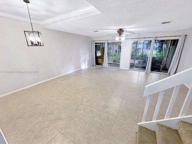 tiled spare room with a textured ceiling, ceiling fan with notable chandelier, and crown molding