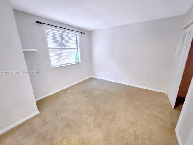 unfurnished room with light colored carpet