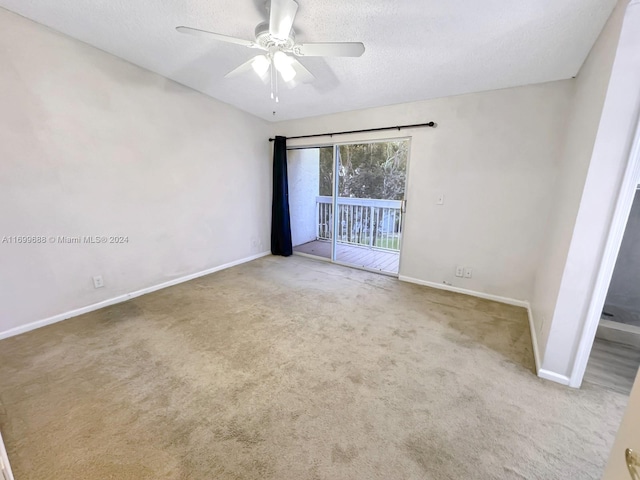 unfurnished room featuring ceiling fan, carpet floors, and a textured ceiling