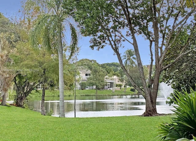 exterior space featuring a lawn and a water view