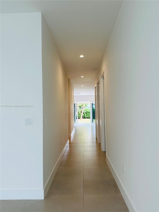 corridor featuring light tile patterned floors