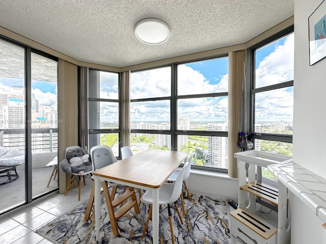 tiled dining area with a wealth of natural light and a textured ceiling